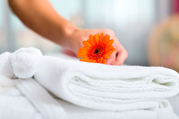 White towel with orange flower on top