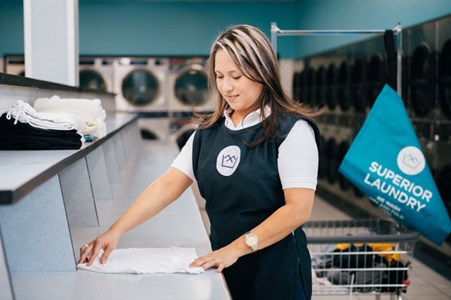 laundromat attendant doing fluff and fold laundry service