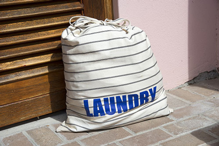 Laundry bag outside of front door ready for pickup