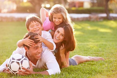 happy-family-playing-outside-home