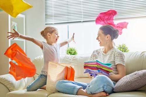 mother-and-daughter-with-clean-laundry-in-apartment